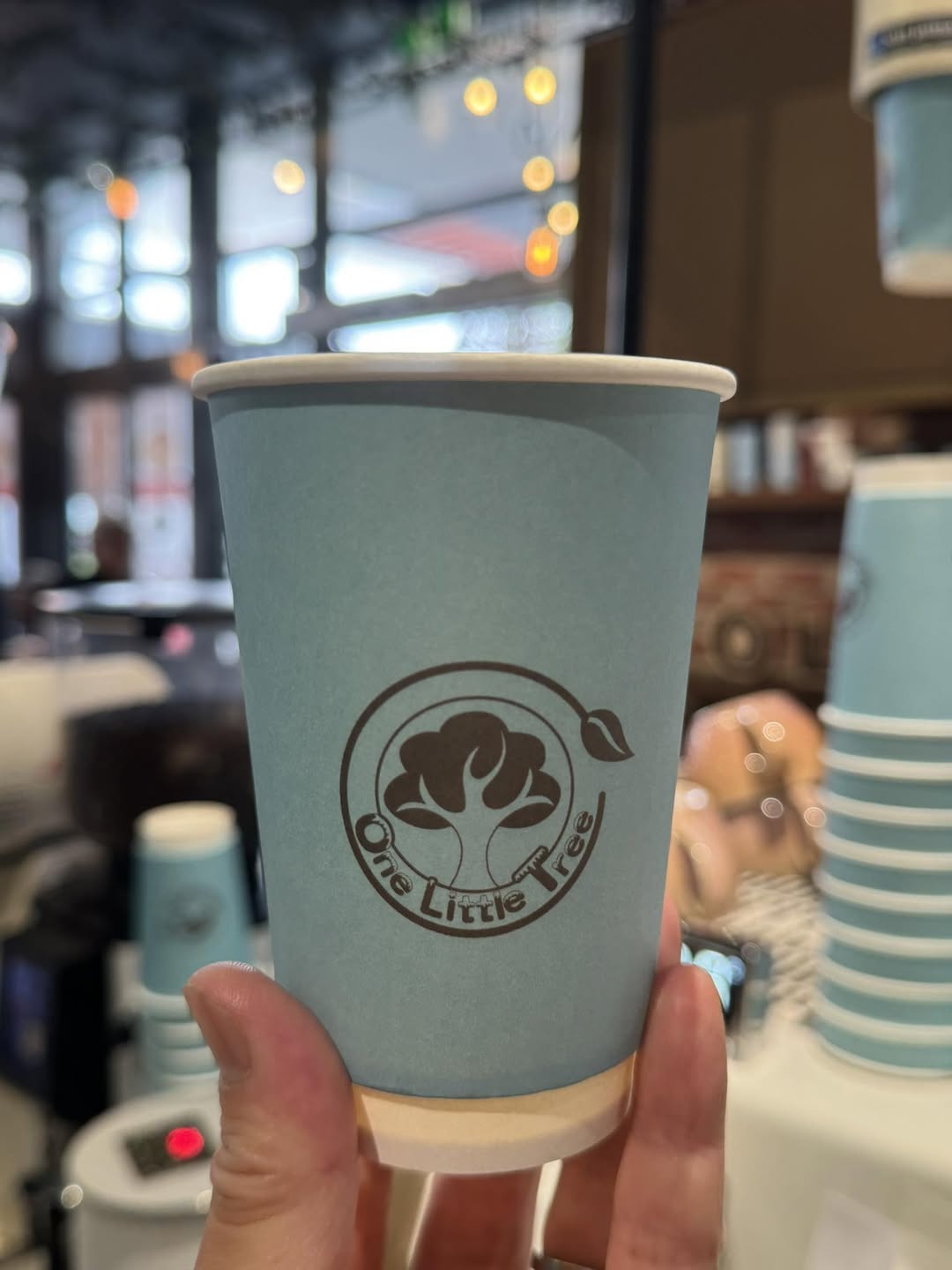 One Little Tree branded takeaway coffee cup