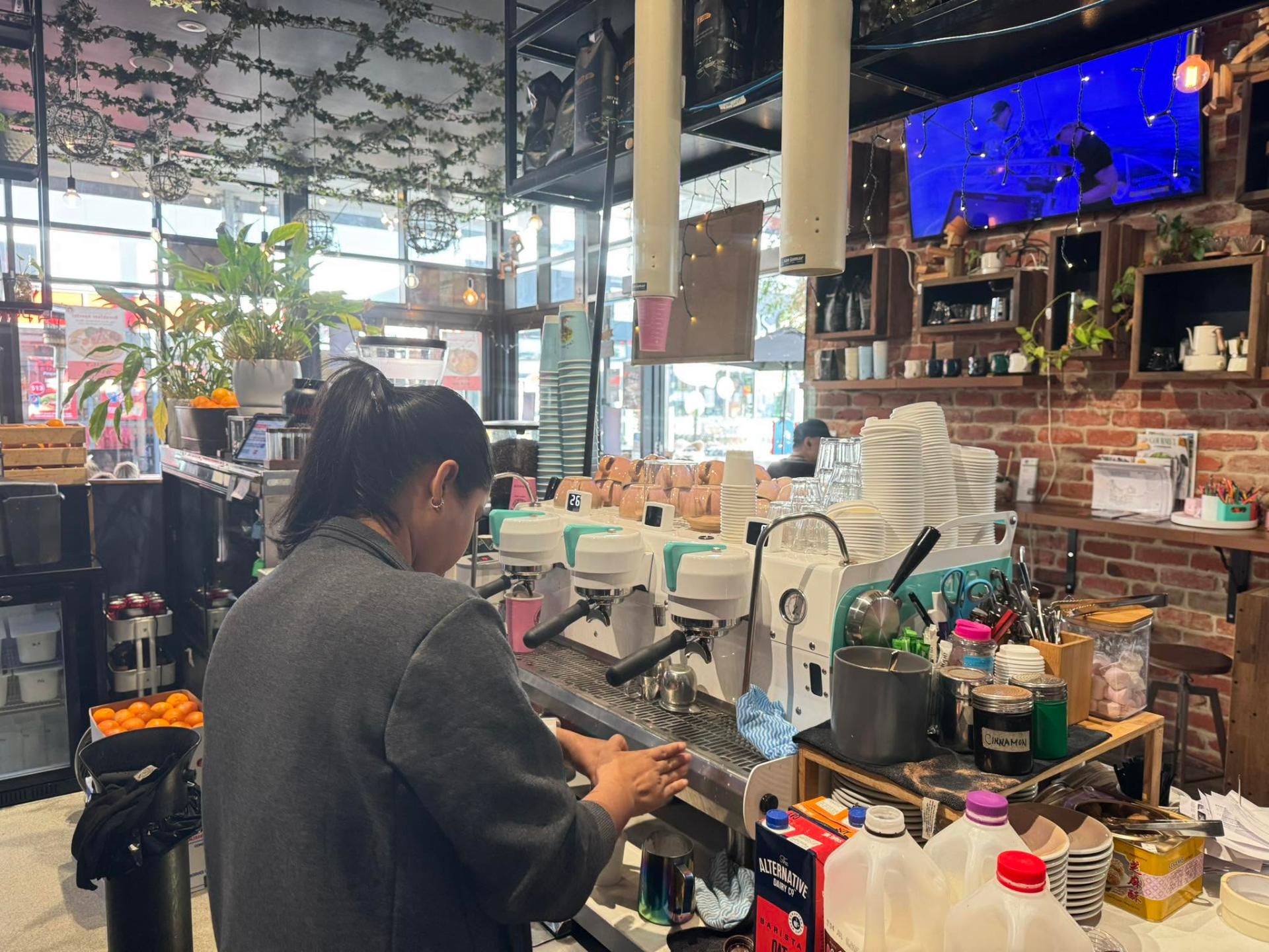 Barista pulling shots at the espresso machine